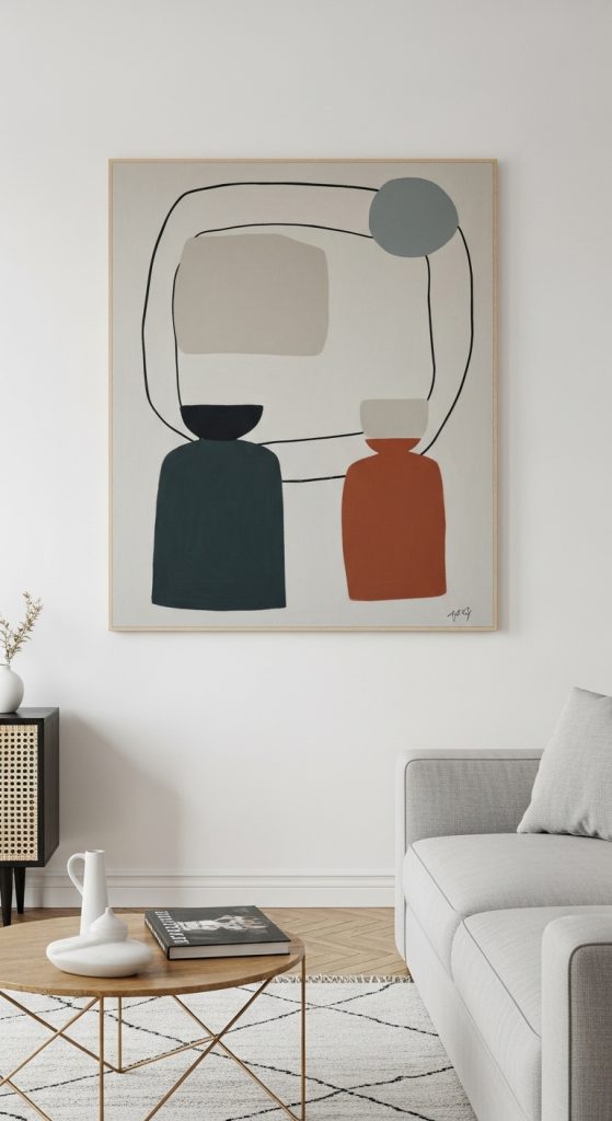 A large abstract art piece with simple forms and neutral colors hanging on the wall of a minimalist living room.